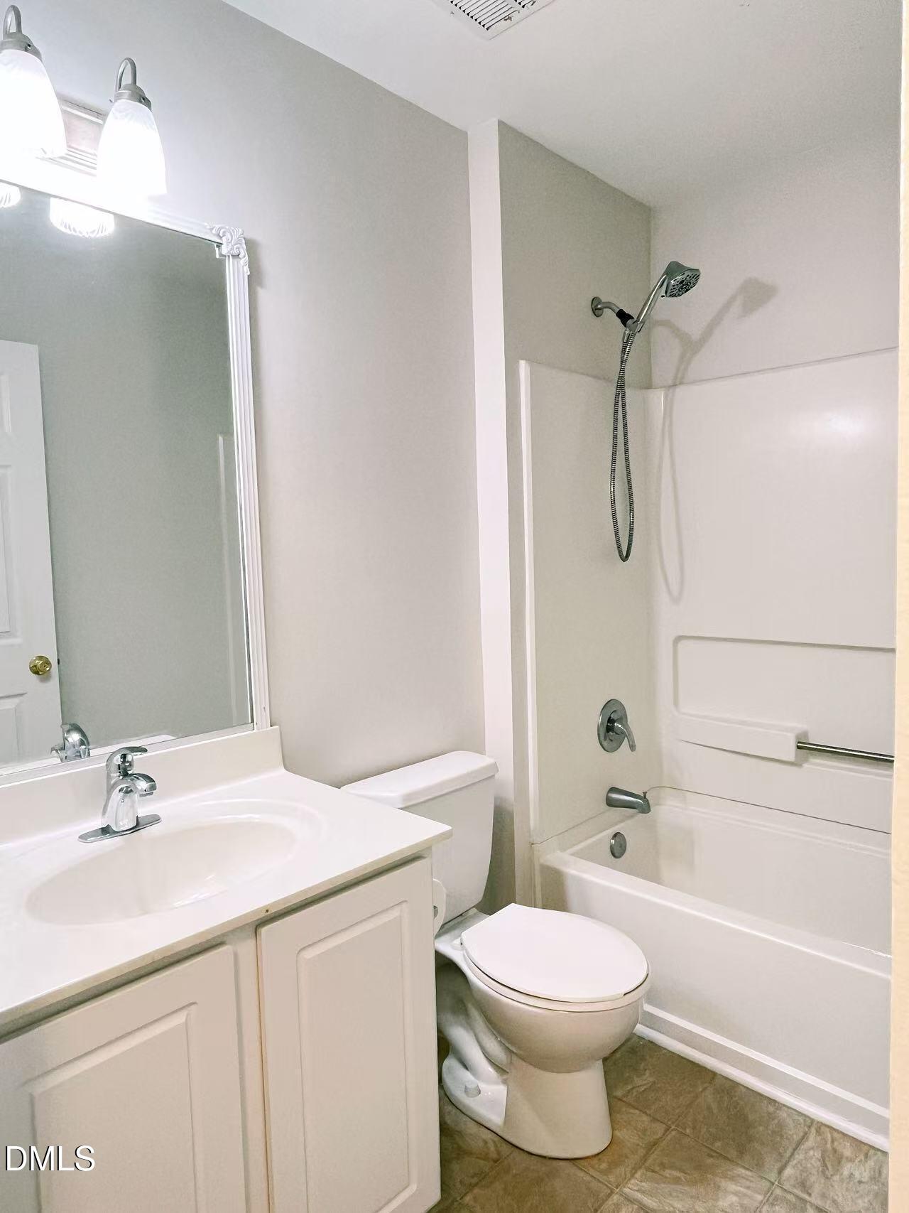 3040 Barrymore Street, Unit 108 Raleigh, NC 27603 - Photo 6 of 13 a bathroom with a sink a toilet and a bathtub