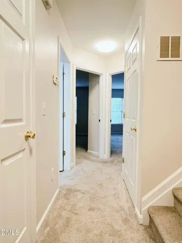 a view of a hallway with wooden shelves