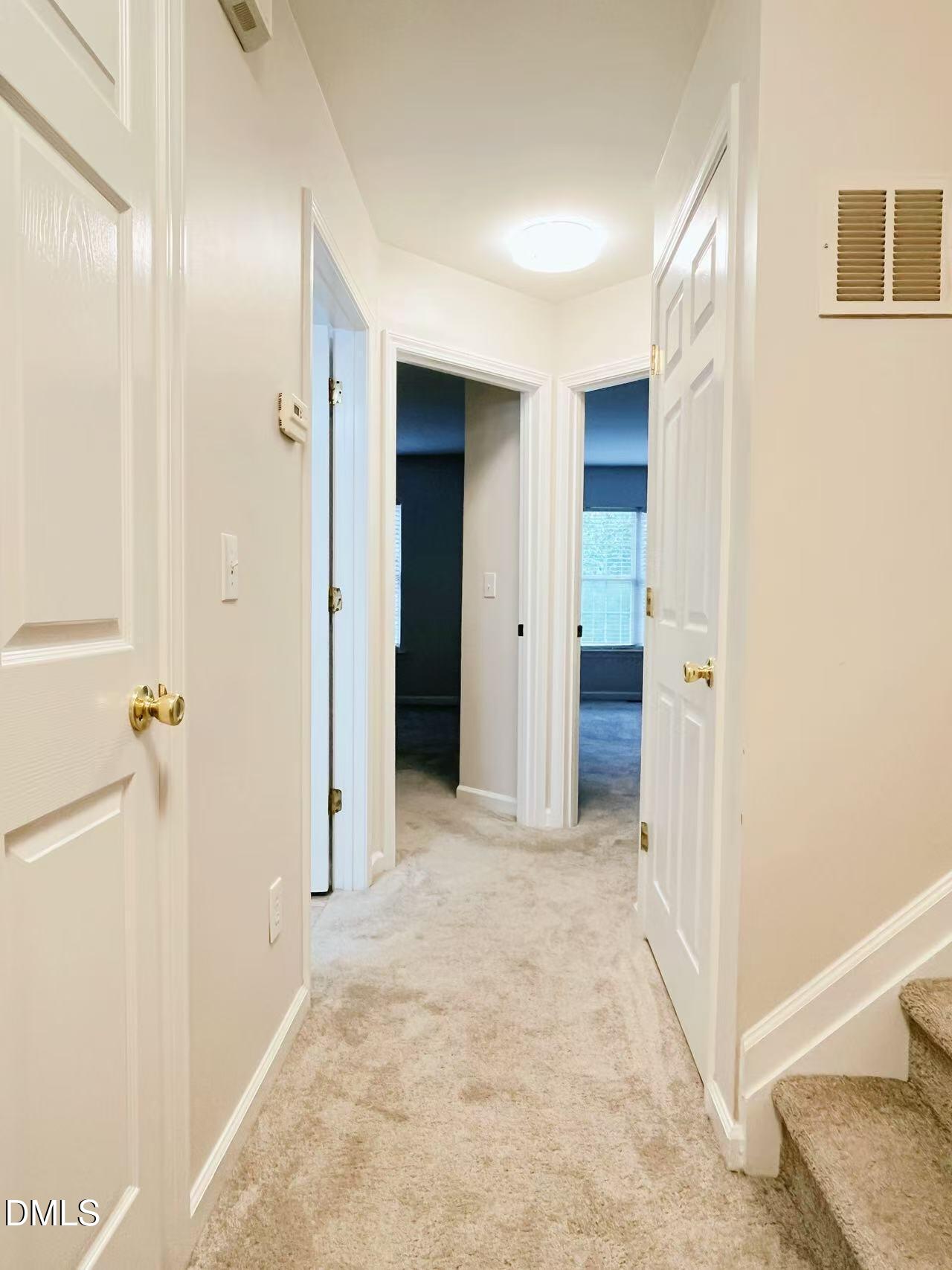 3040 Barrymore Street, Unit 108 Raleigh, NC 27603 - Photo 8 of 13 a view of a hallway with wooden shelves