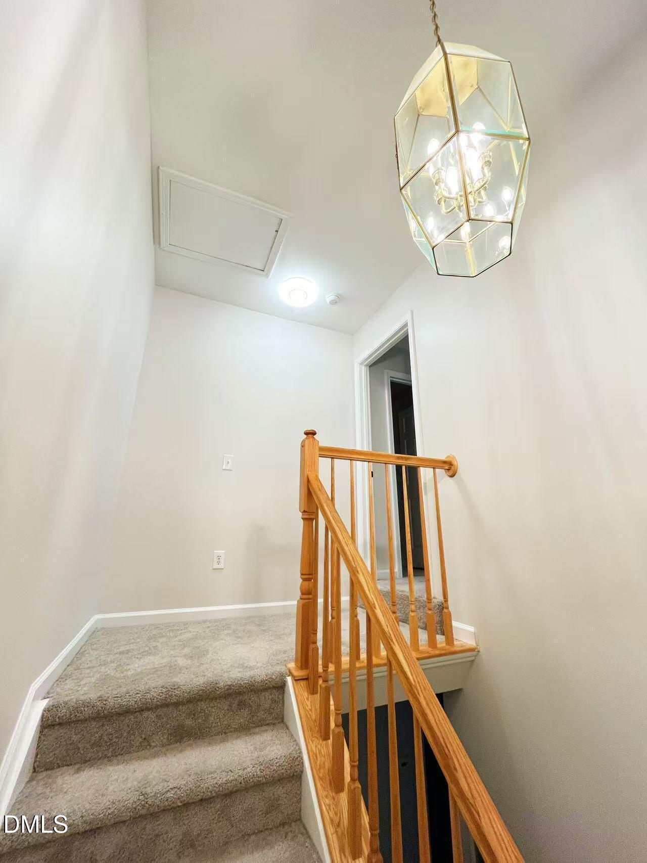 3040 Barrymore Street, Unit 108 Raleigh, NC 27603 - Photo 9 of 13 a view of staircase with railing and white walls
