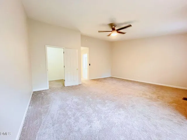 an empty room with closet and windows