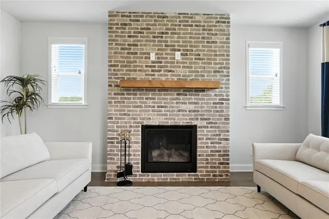 a living room with furniture a window and a fireplace