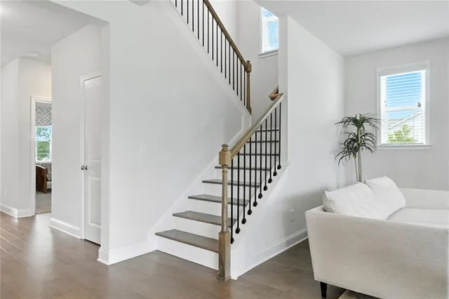 a view of entryway and hall with wooden floor