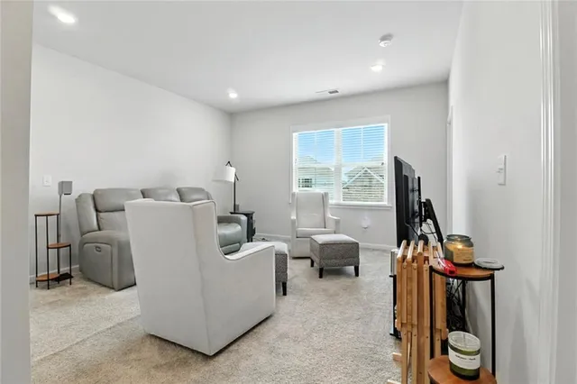 a living room with furniture a window and a flat screen tv