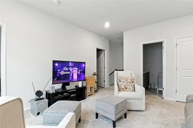 a living room with furniture a rug and a projector