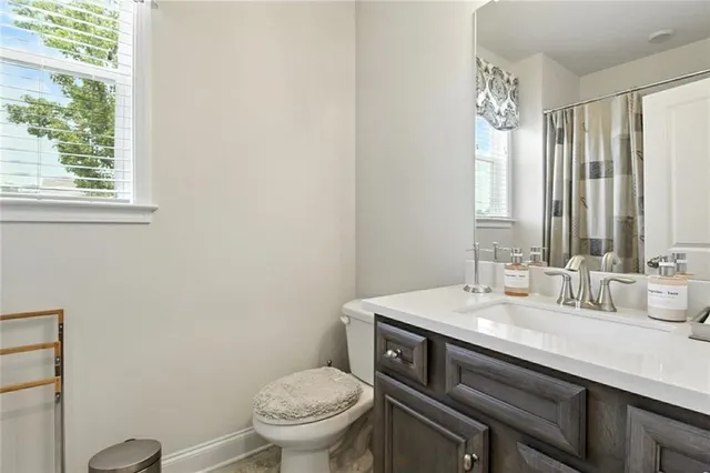 a bathroom with a sink a toilet and a mirror