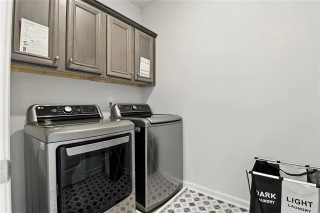 a view of a storage and utility room with washer and dryer