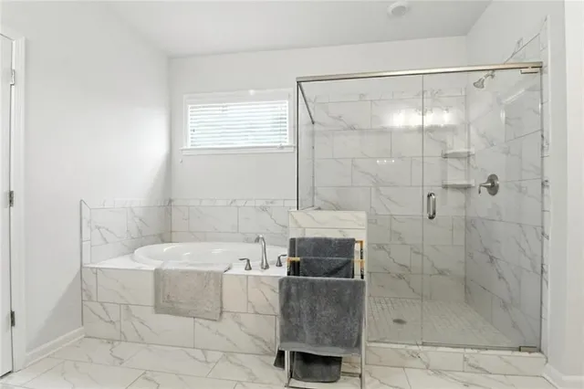 a bathroom with a bathtub and shower