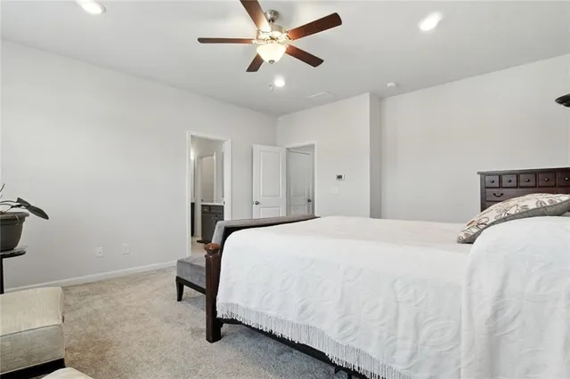 a bedroom with a bed and a ceiling fan