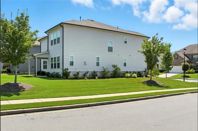 a front view of a house with a yard