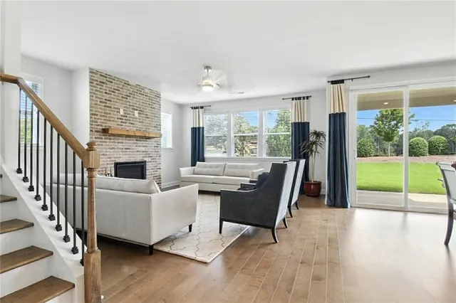 a view of a livingroom with furniture wooden floor and windows