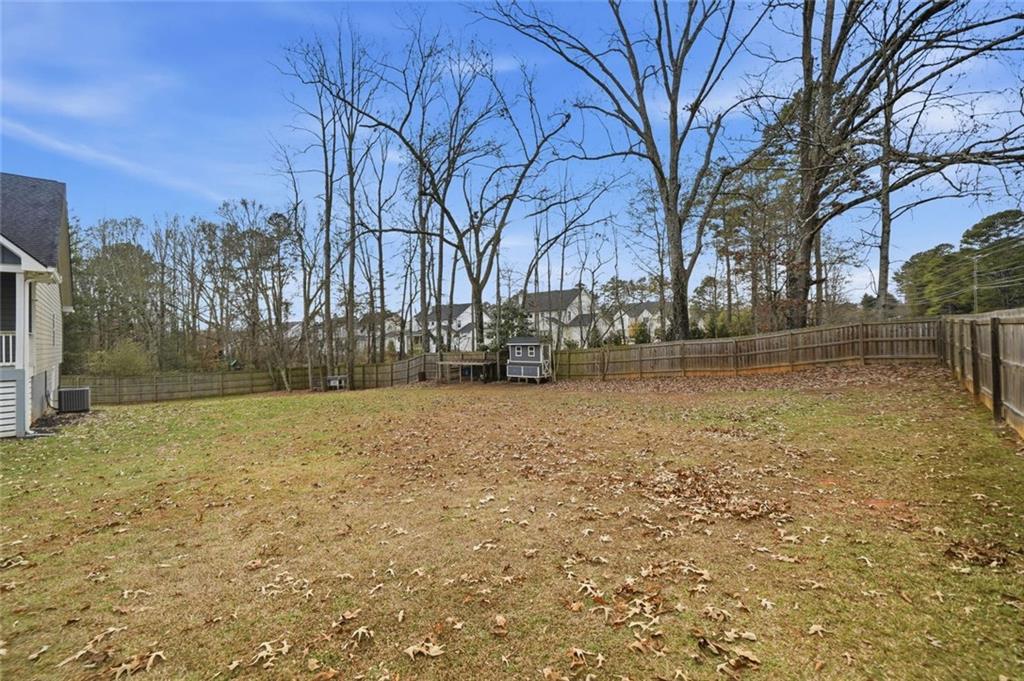 1006 Owens Store Road Canton, GA 30115 - Photo 40 of 48 a backyard of a house with lots of green space