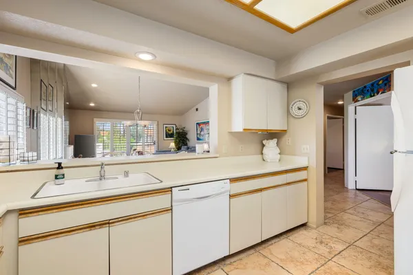 a kitchen with cabinets stainless steel appliances and a sink