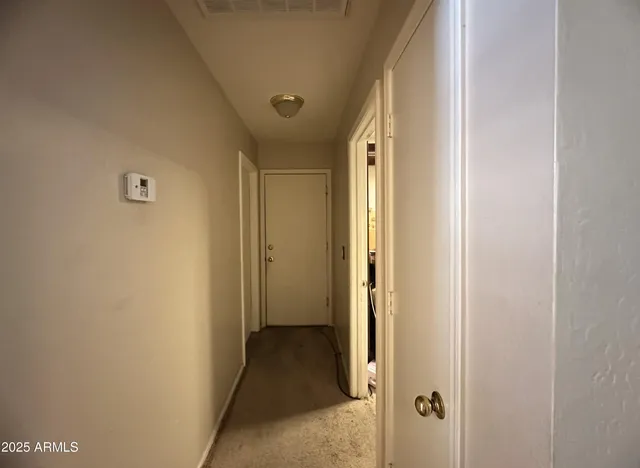 a view of a hallway with a wooden door