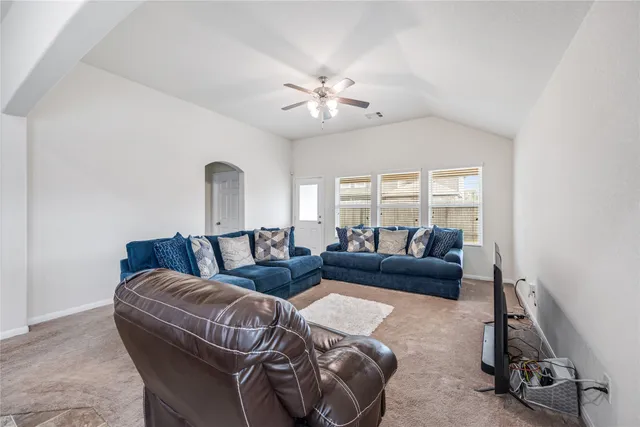 a kitchen with kitchen island granite countertop a sink stove refrigerator and cabinets