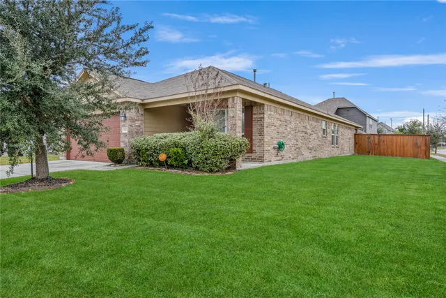 a view of a hallway with a livingroom and a bathroom with sink