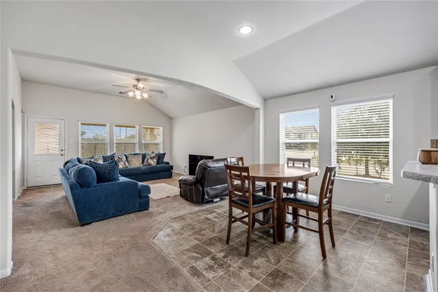 a kitchen with stainless steel appliances kitchen island granite countertop a sink stove and refrigerator