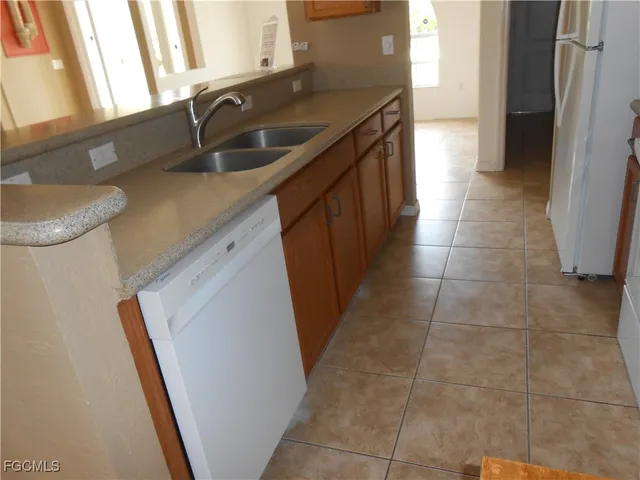 a kitchen with a sink a stove and a refrigerator