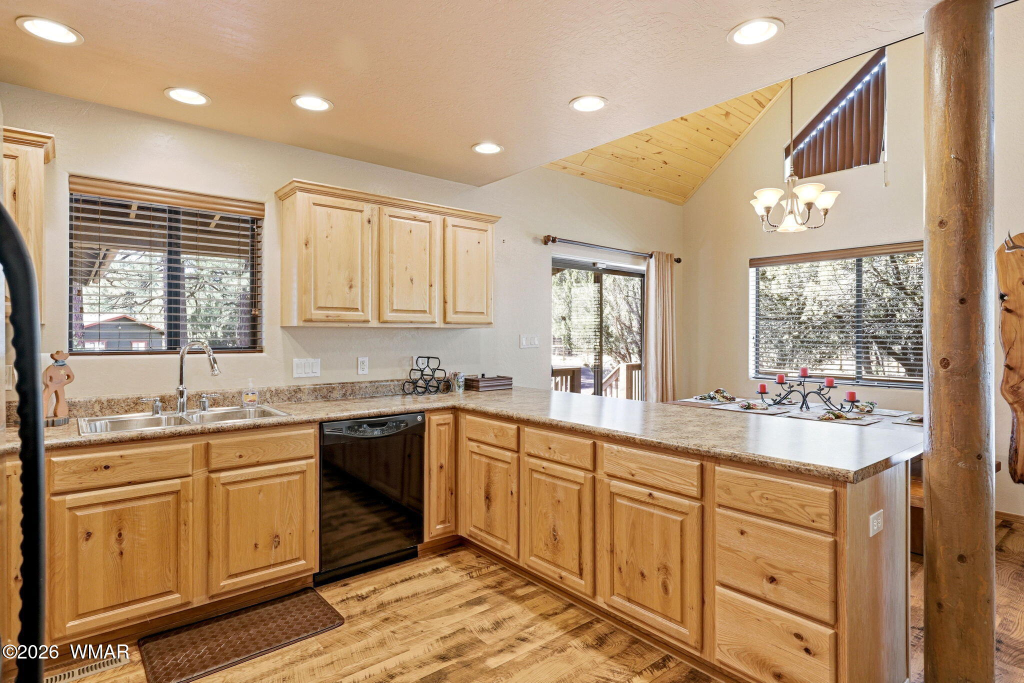 2877 Wahoo Road Overgaard, AZ 85933 - Photo 13 of 42 a large white kitchen with a sink window and cabinets