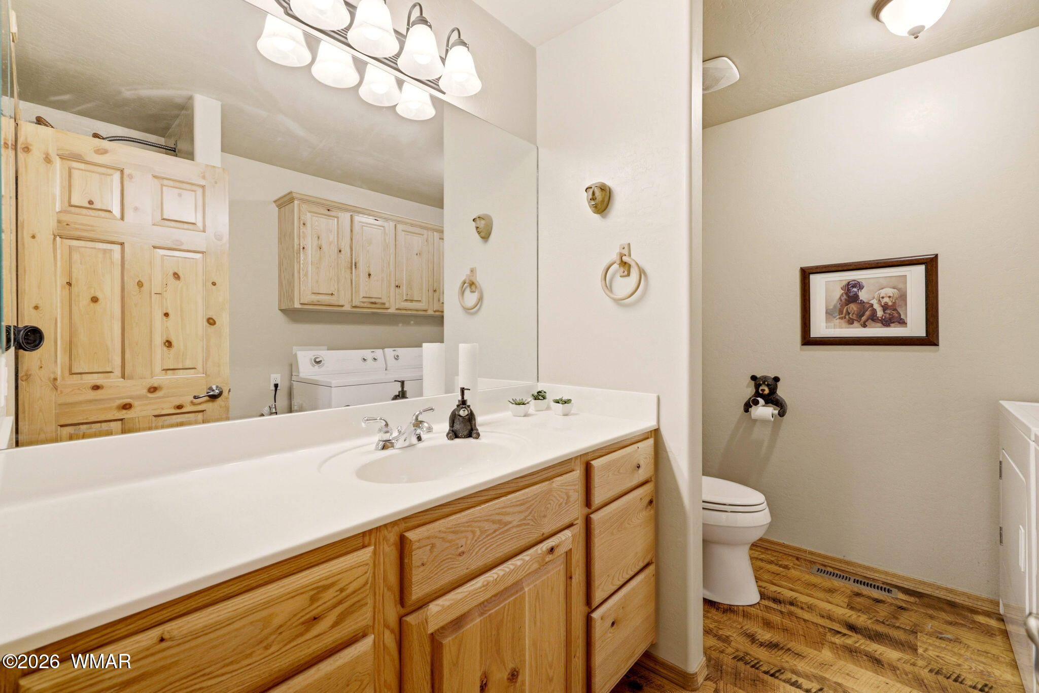 2877 Wahoo Road Overgaard, AZ 85933 - Photo 15 of 42 a bathroom with a sink a toilet and a large mirror