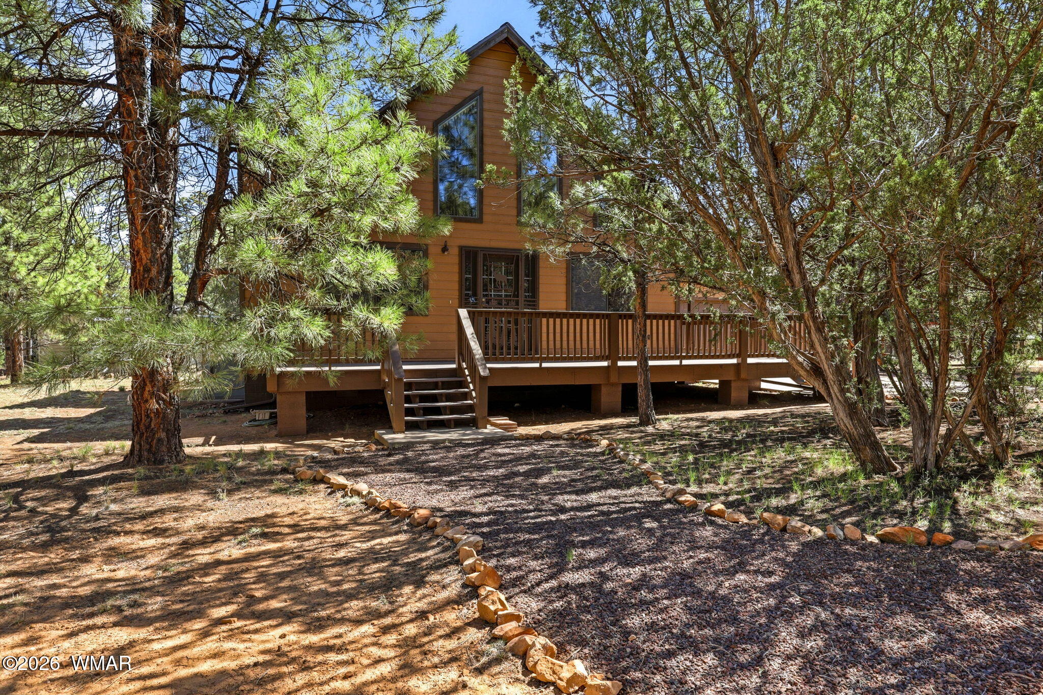 2877 Wahoo Road Overgaard, AZ 85933 - Photo 2 of 42 a backyard of a house with lots of green space