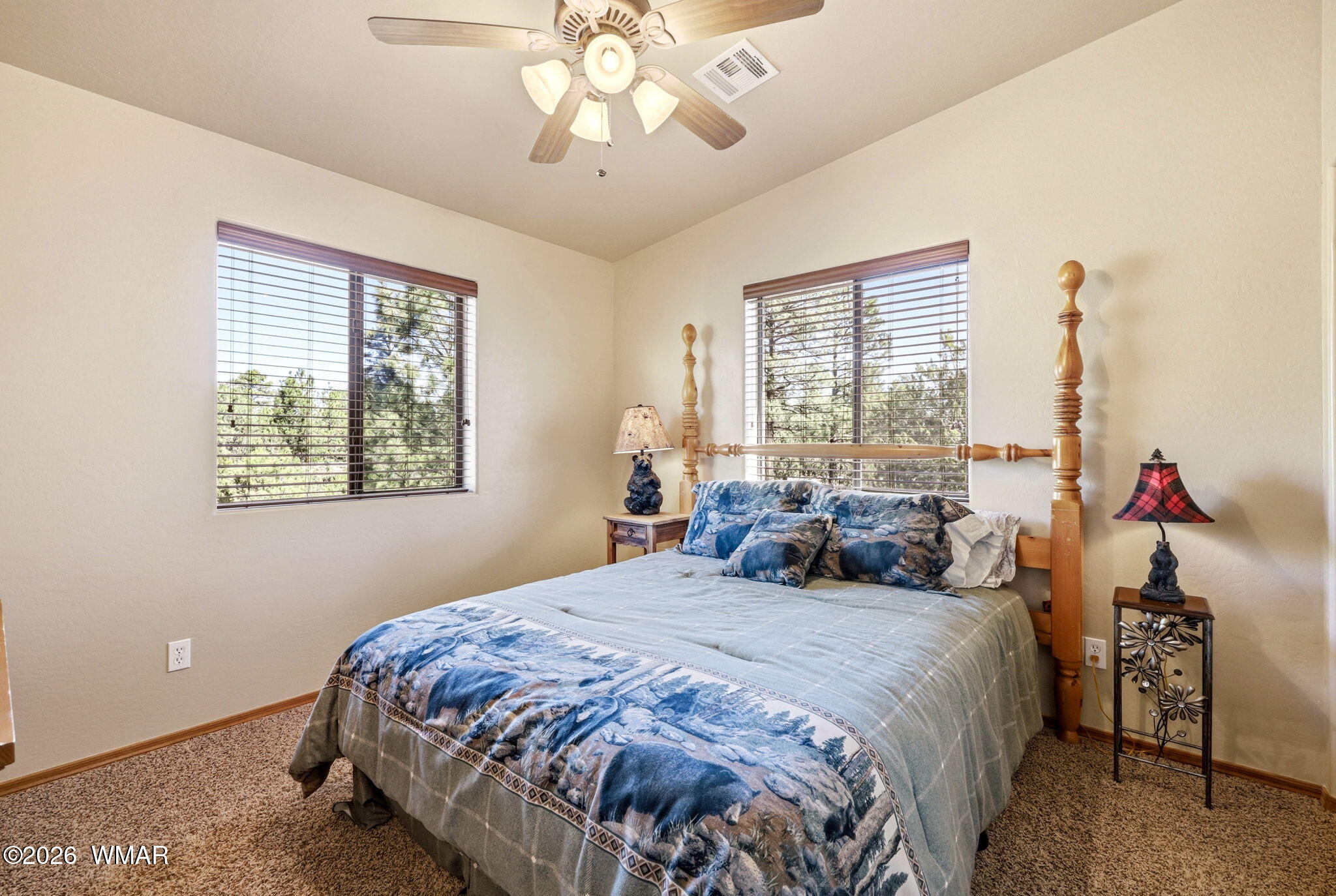 2877 Wahoo Road Overgaard, AZ 85933 - Photo 25 of 42 a bedroom with a bed and a chandelier