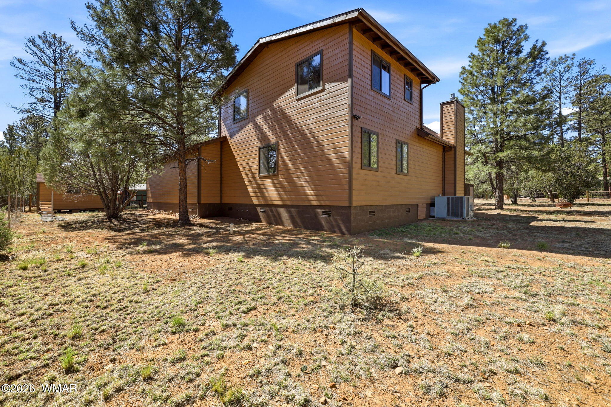 2877 Wahoo Road Overgaard, AZ 85933 - Photo 29 of 42 a front view of a house with a yard