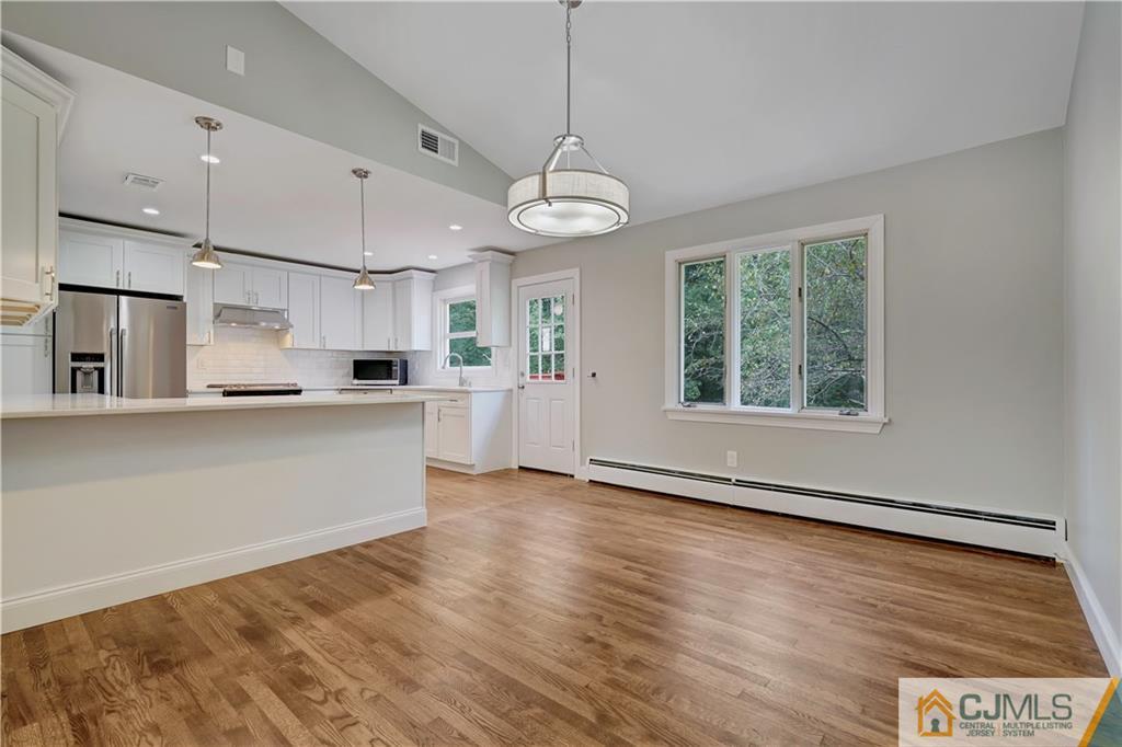 203 Riverbend Road Berkeley Heights, NJ 07922 - Photo 17 of 42 a view of an empty room with wooden floor and a window