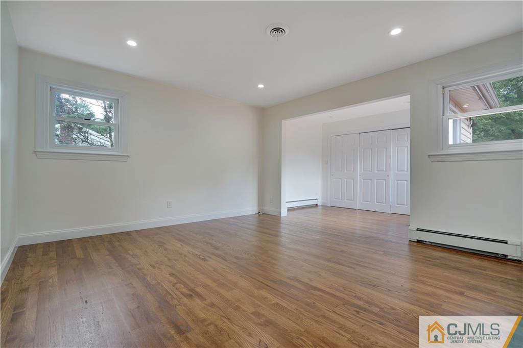 203 Riverbend Road Berkeley Heights, NJ 07922 - Photo 23 of 42 an empty room with wooden floor and windows