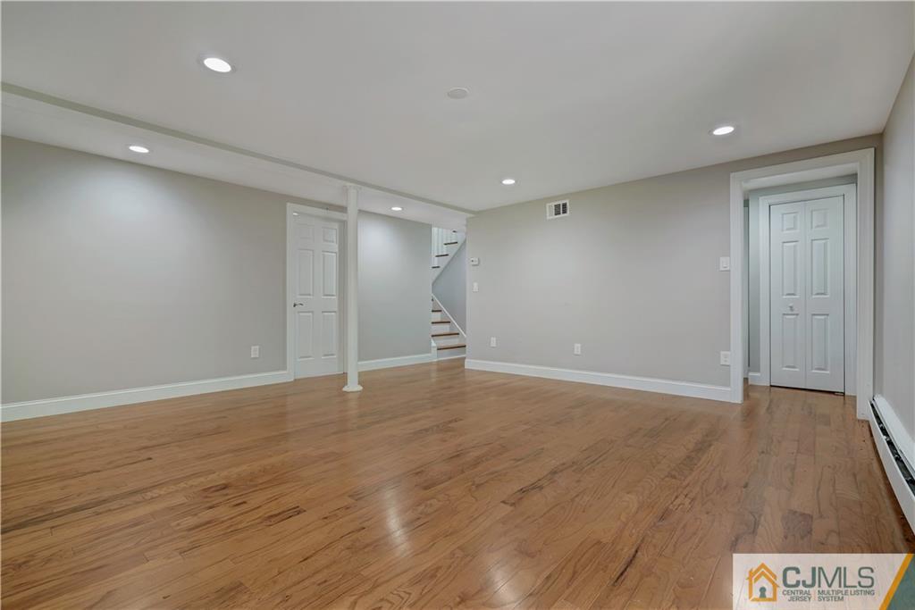 203 Riverbend Road Berkeley Heights, NJ 07922 - Photo 4 of 42 a view of an empty room with wooden floor