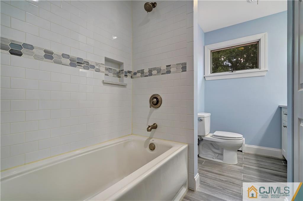 203 Riverbend Road Berkeley Heights, NJ 07922 - Photo 33 of 42 a bathroom with a bath tub a toilet and a shower