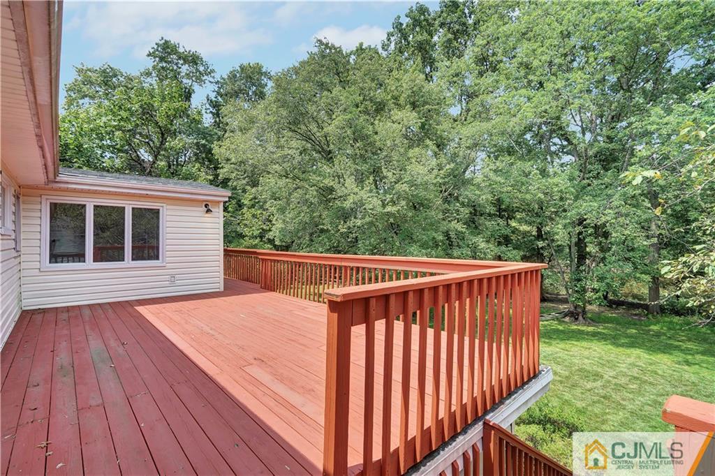 203 Riverbend Road Berkeley Heights, NJ 07922 - Photo 35 of 42 a balcony with wooden floor and yard in the back