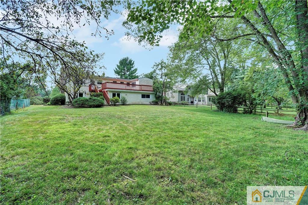 203 Riverbend Road Berkeley Heights, NJ 07922 - Photo 40 of 42 a white house with a big yard and large trees