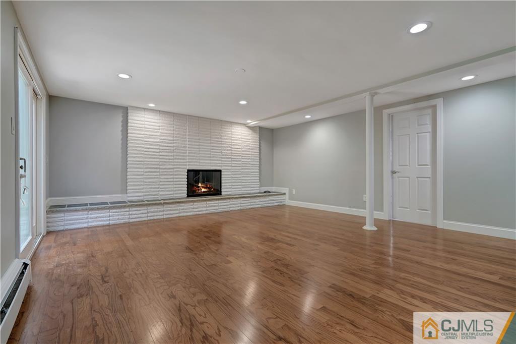 203 Riverbend Road Berkeley Heights, NJ 07922 - Photo 5 of 42 a view of an empty room with wooden floor and a window