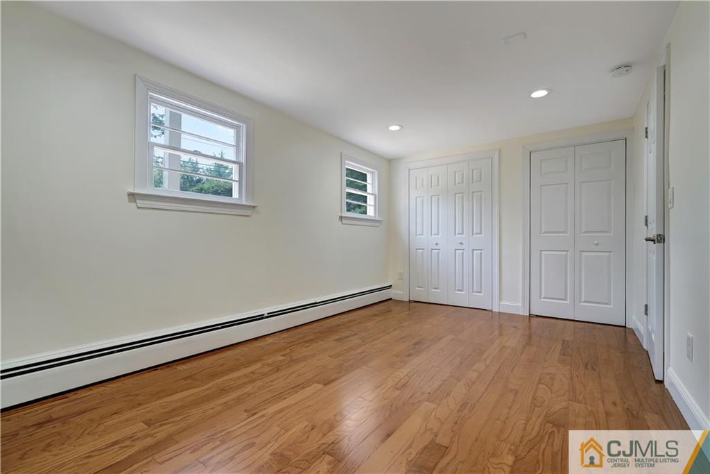 203 Riverbend Road Berkeley Heights, NJ 07922 - Photo 7 of 42 a view of an empty room with wooden floor and a window
