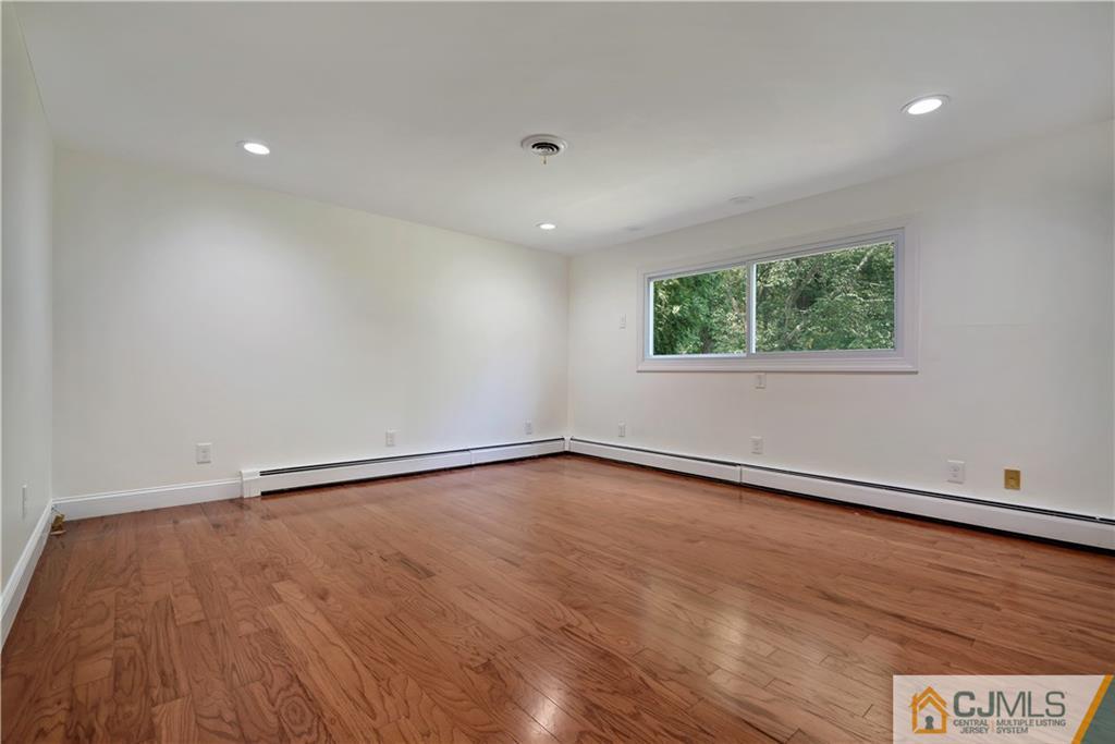 203 Riverbend Road Berkeley Heights, NJ 07922 - Photo 8 of 42 wooden floor in an empty room with a window