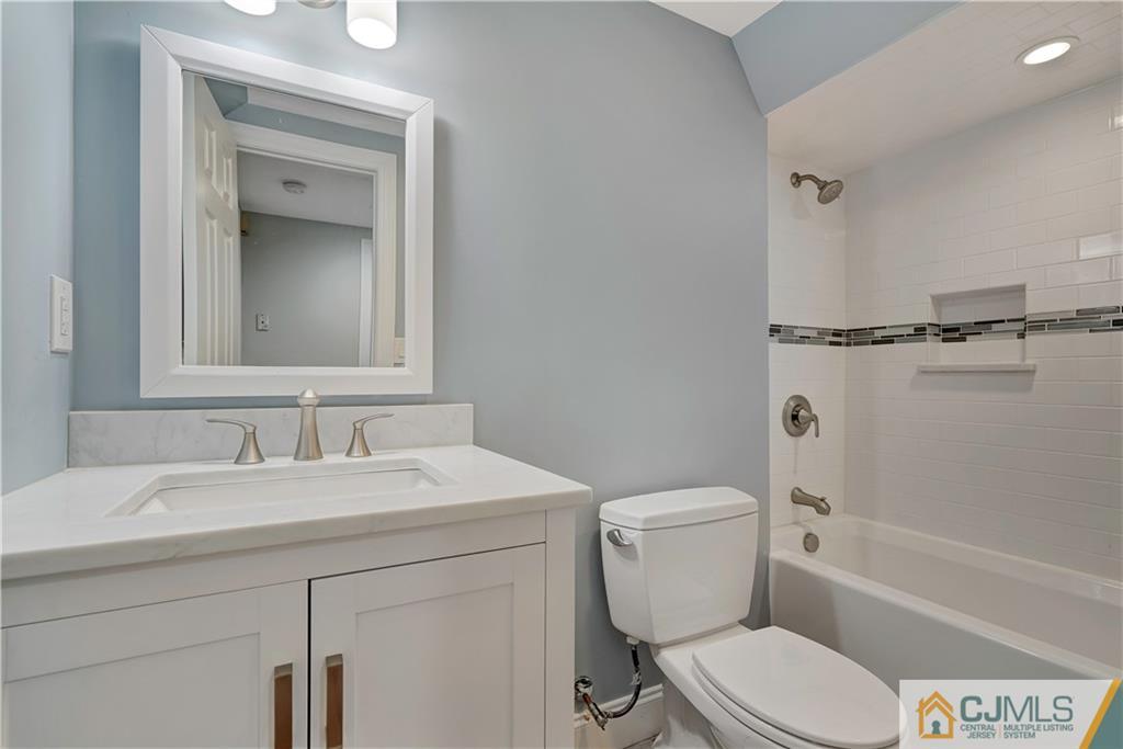 203 Riverbend Road Berkeley Heights, NJ 07922 - Photo 10 of 42 a bathroom with a toilet sink vanity tub and shower