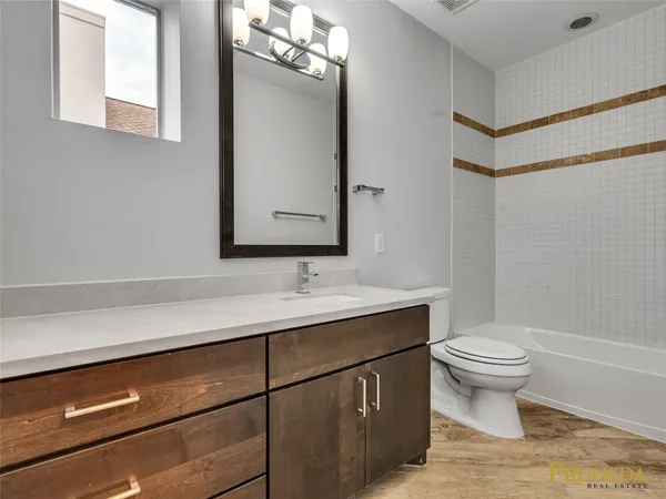 a bathroom with a toilet a sink and a mirror