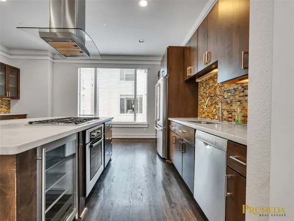 a kitchen with stainless steel appliances granite countertop a stove and a sink