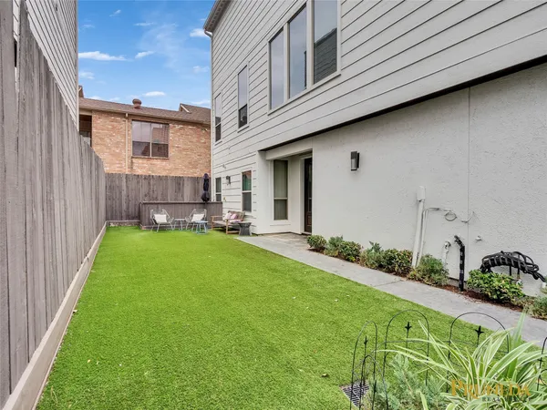 a backyard of a house with table and chairs