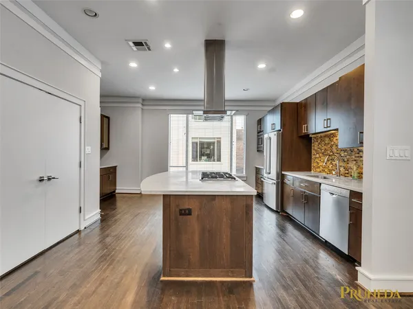 a kitchen with stainless steel appliances granite countertop a stove and a refrigerator