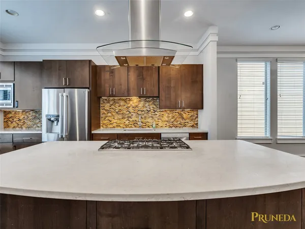a view of kitchen with stainless steel appliances a refrigerator and microwave