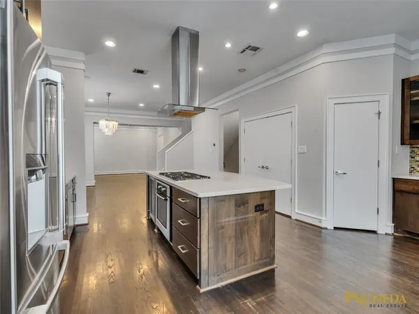 a kitchen with a stove and a refrigerator