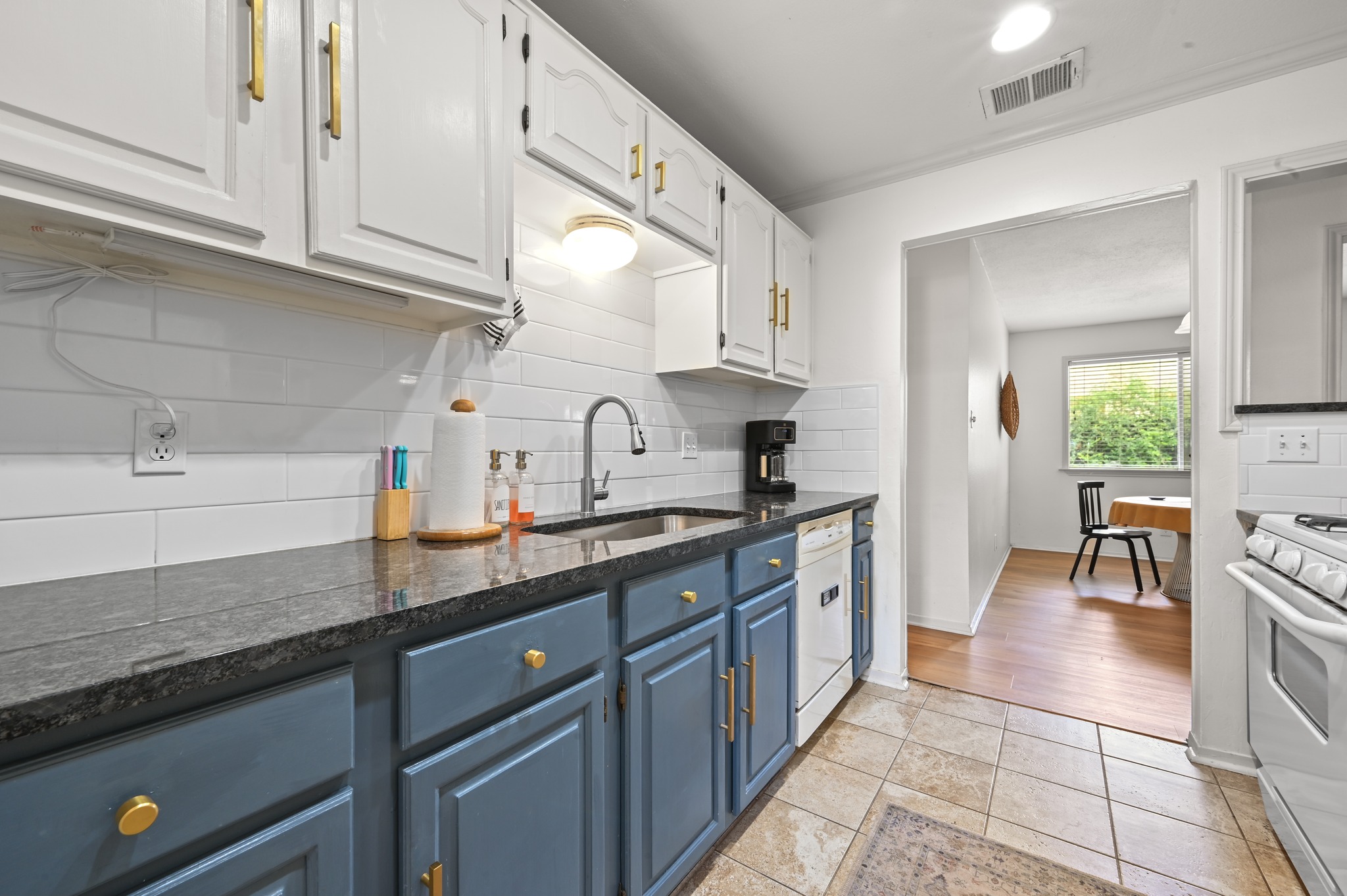 6805 Rearden Road Austin, TX 78745 - Photo 11 of 26 Granite counters and stainless steel appliances elevate this functional kitchen space.