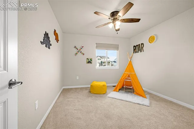 wooden floor & ceiling fan in a room