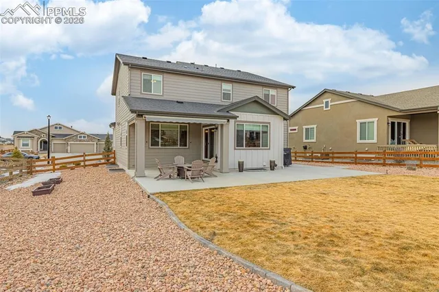 a view of a house with swimming pool and furniture