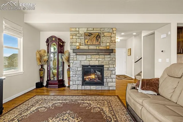a living room with furniture a rug and a fireplace