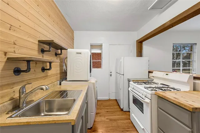 a kitchen that has a sink and a stove
