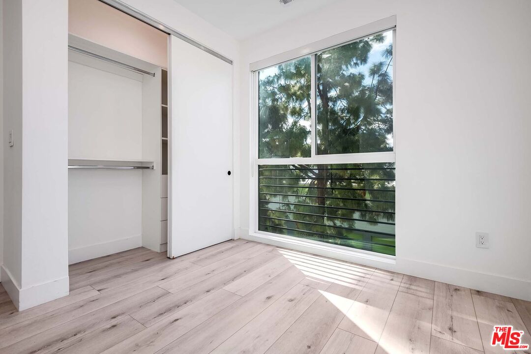 15330 Weddington Street Sherman Oaks, CA 91411 - Photo 18 of 30 a view of an empty room with wooden floor and a window