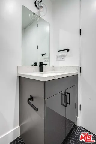 a bathroom with a sink and a mirror